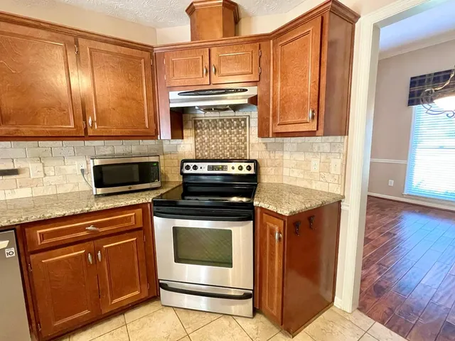 a view of a room with a empty space and window
