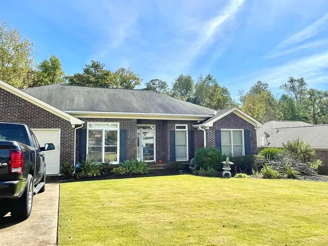 a view of an empty room window and wooden floor