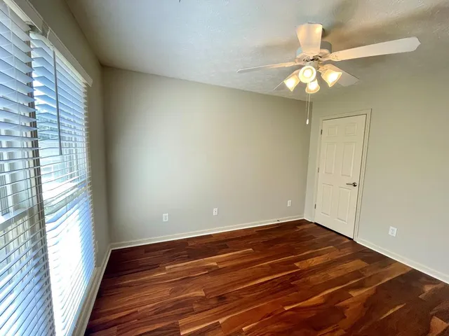 a bathroom with a glass door shower and a toilet