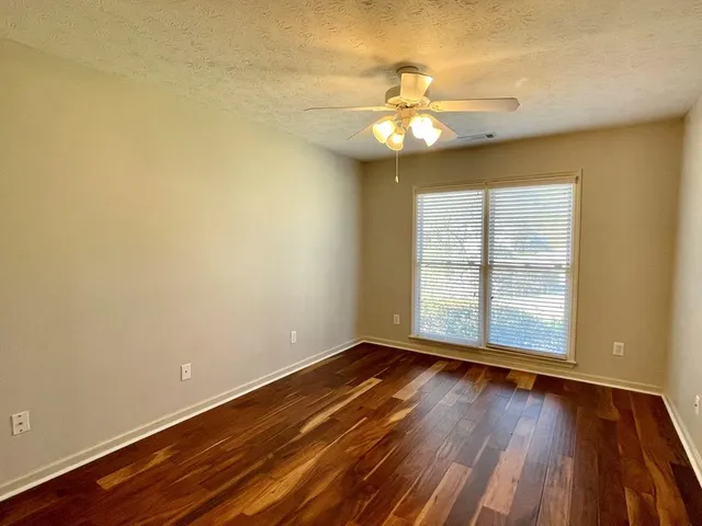 a bathroom with a granite countertop tub sink and mirror