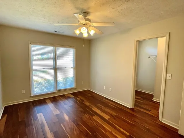 a bathroom with a tub a double vanity sink and a mirror
