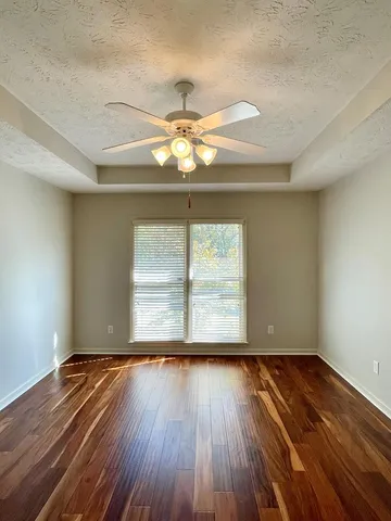 a view of a yard with wooden fence