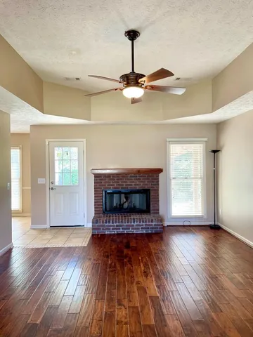 an empty room with wooden floor painted walls and stairs
