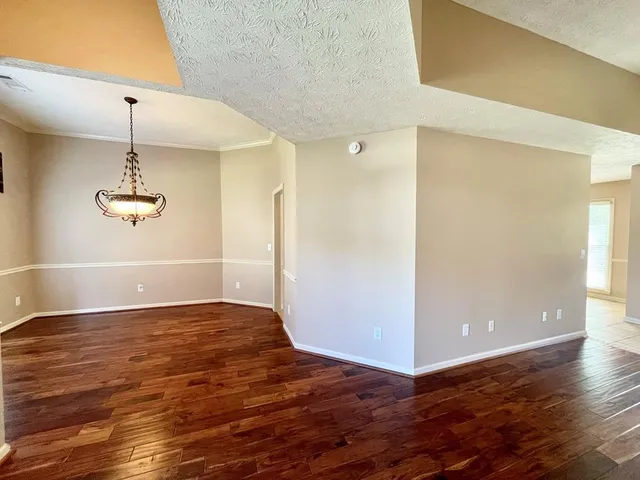 a view of a room with wooden floor and window