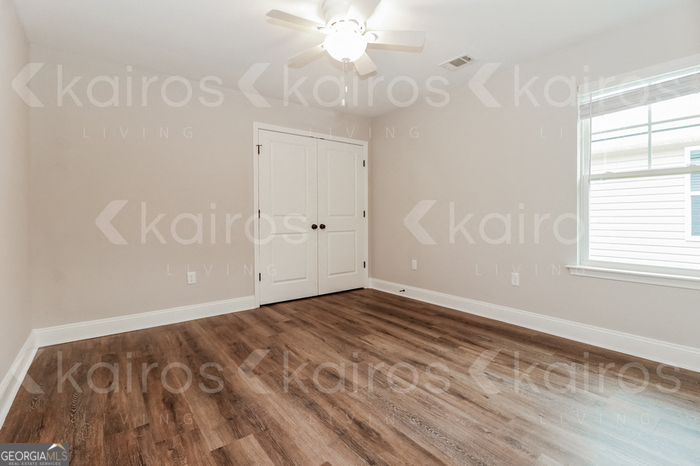 155 Cottage Grove Road Brunswick, GA 31525 - Photo 12 of 16 a view of an empty room with window and chandelier fan