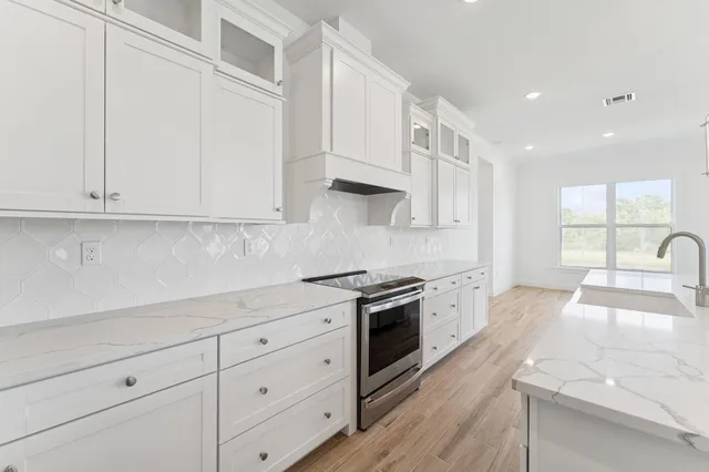 a kitchen with cabinets and stainless steel appliances