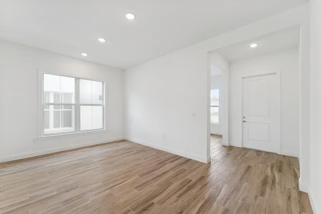 wooden floor in an empty room with a window