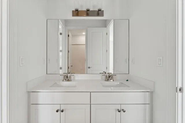 a bathroom with a tub shower vanity and a toilet