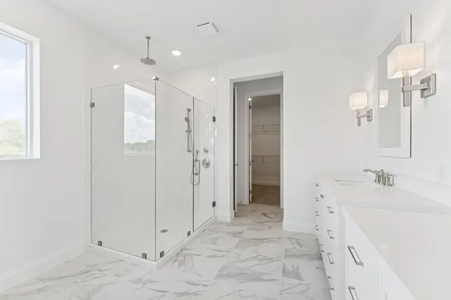 a spacious bathroom with a granite countertop sink mirror and a