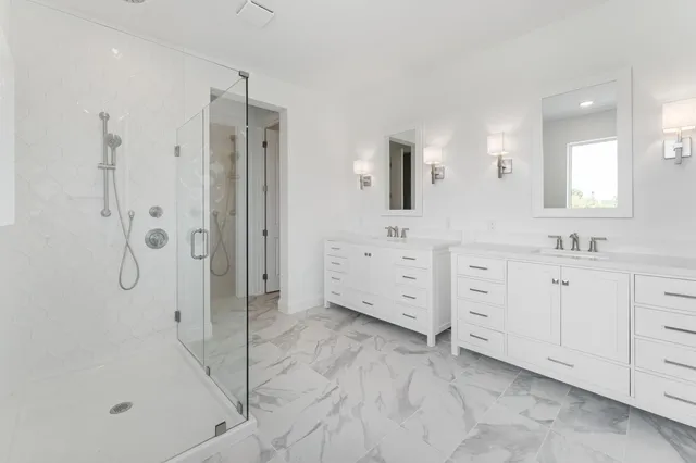 a spacious bathroom with a granite countertop toilet a sink and a mirror