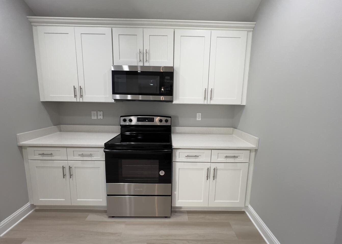 430 Scooter Cove Crestview, FL 32539 - Photo 2 of 4 a kitchen with stainless steel appliances granite countertop white cabinets stove top oven and sink