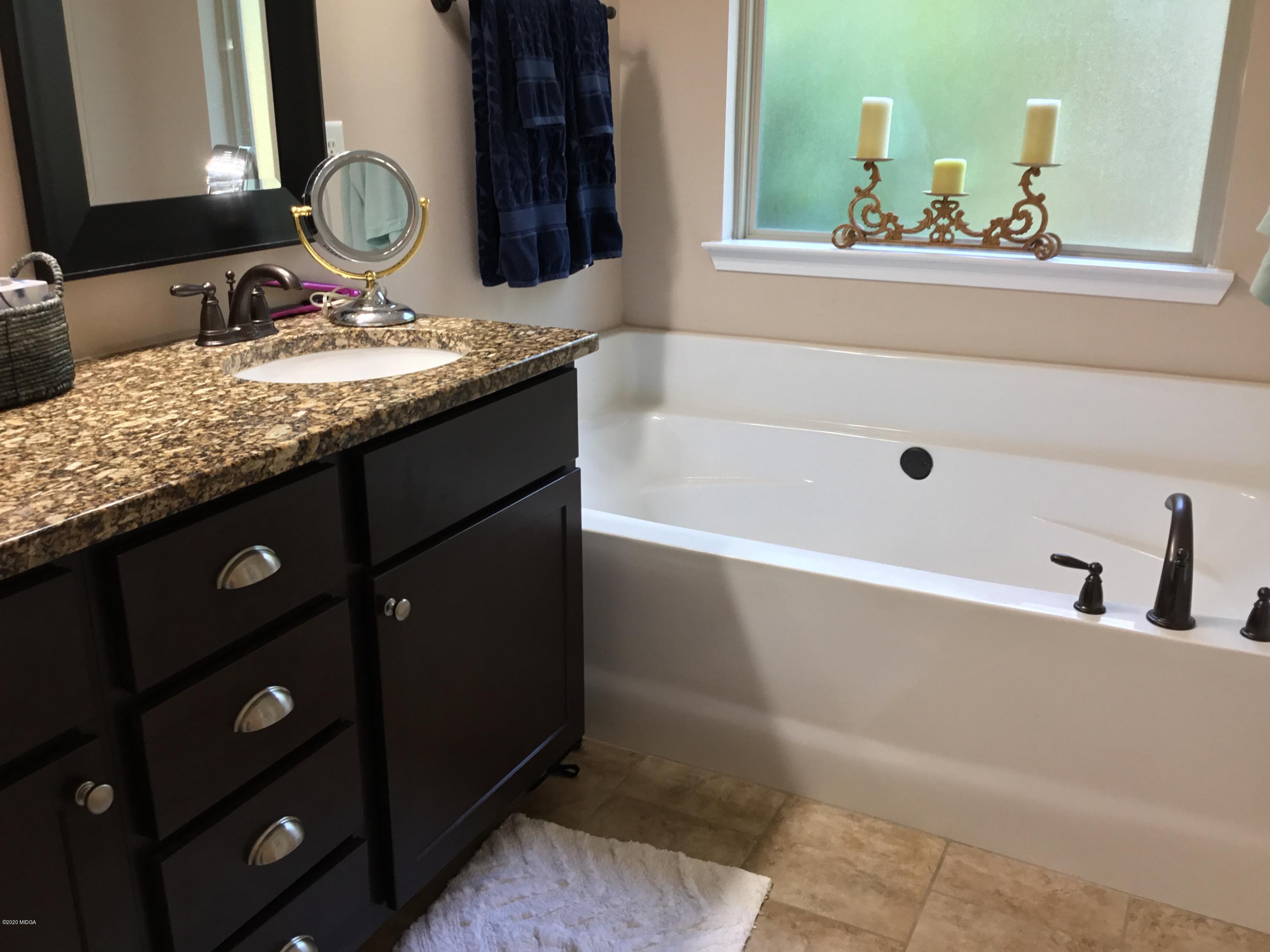 324 Walnut Grove Road Gray, GA 31032 - Photo 16 of 37 a bathroom with a granite countertop sink and a mirror