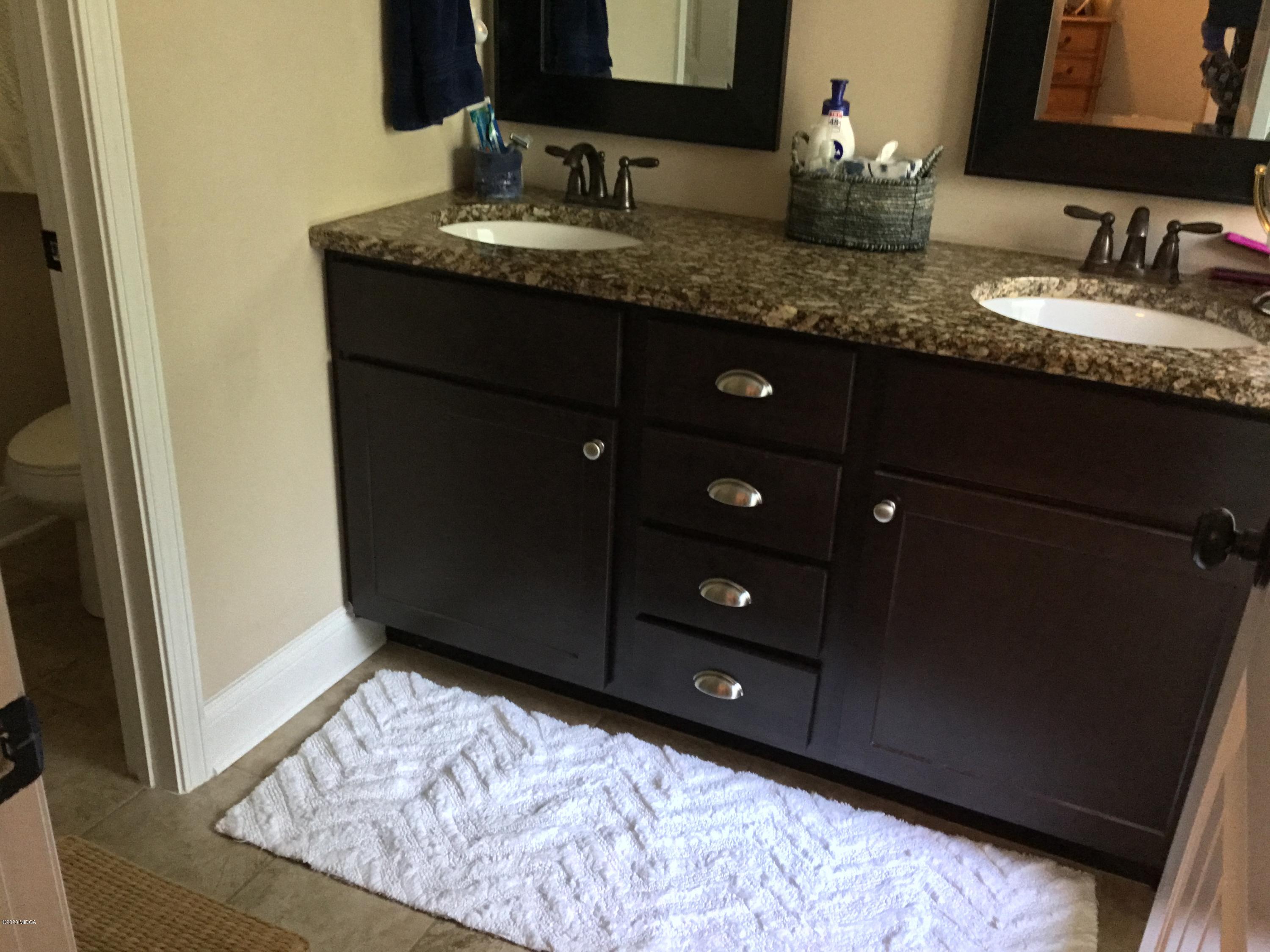 324 Walnut Grove Road Gray, GA 31032 - Photo 17 of 37 a bathroom with a granite countertop sink and a mirror