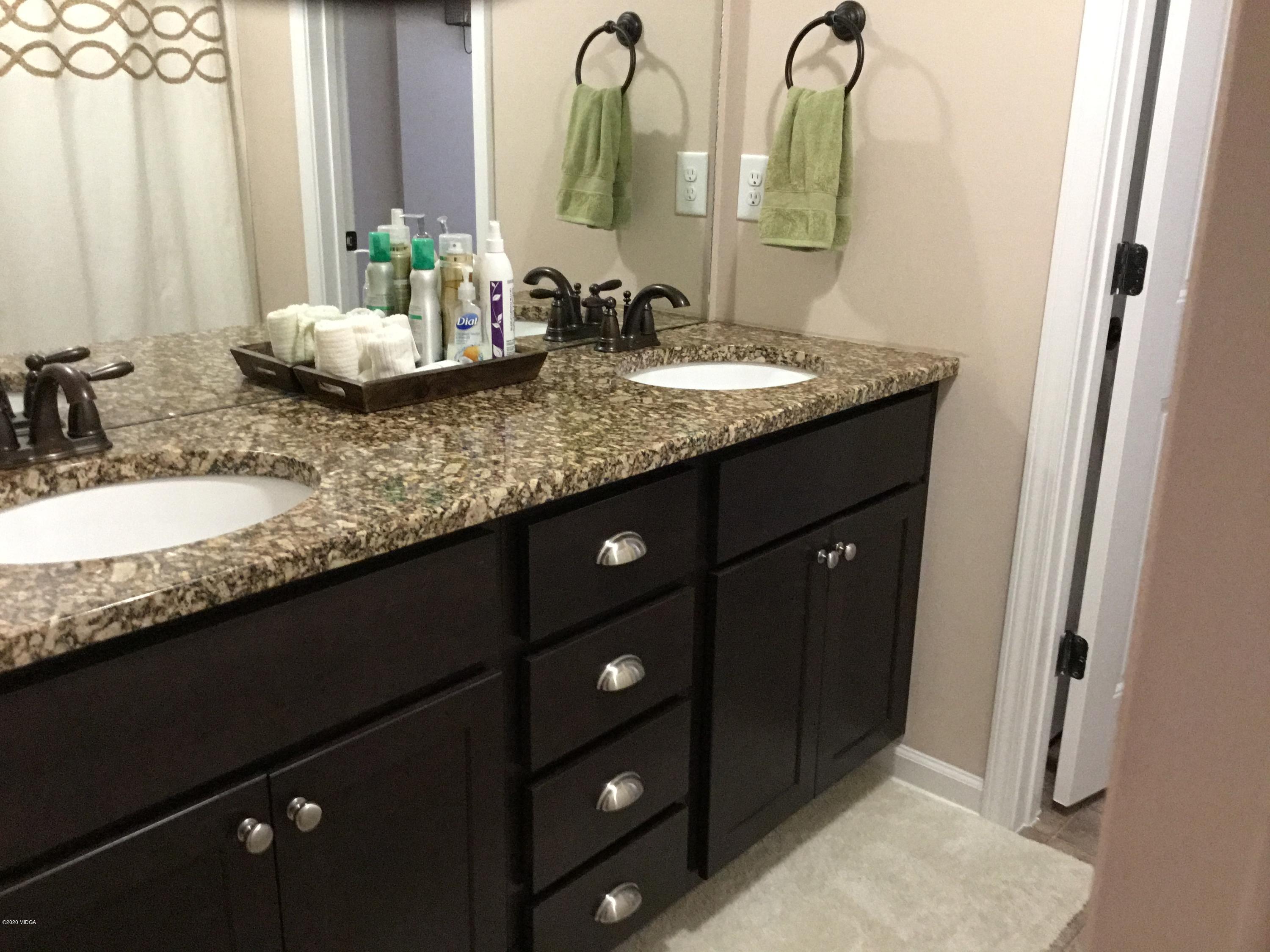324 Walnut Grove Road Gray, GA 31032 - Photo 21 of 37 a bathroom with a granite countertop sink and a mirror