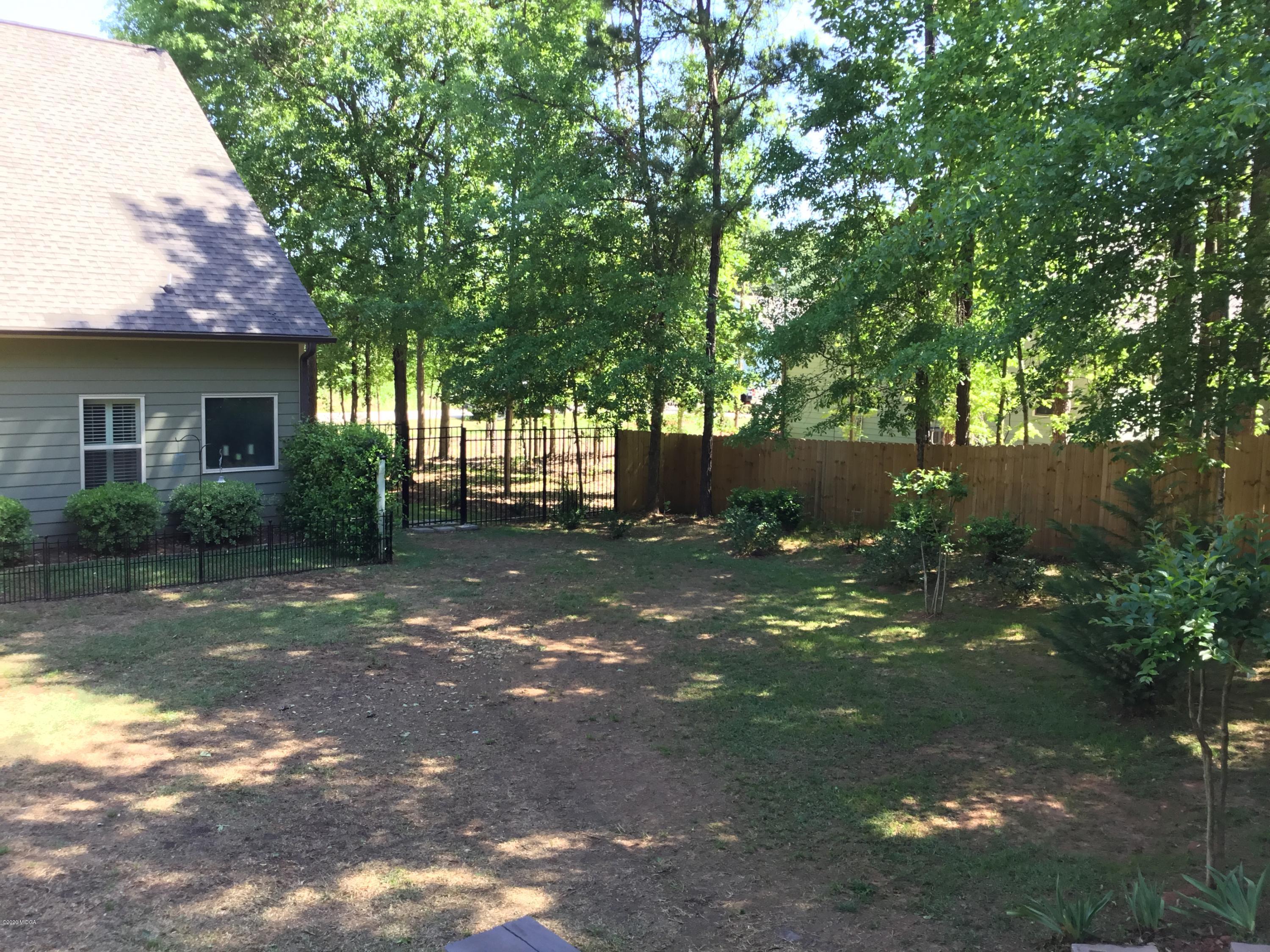 324 Walnut Grove Road Gray, GA 31032 - Photo 31 of 37 a view of a yard with plants and a large tree