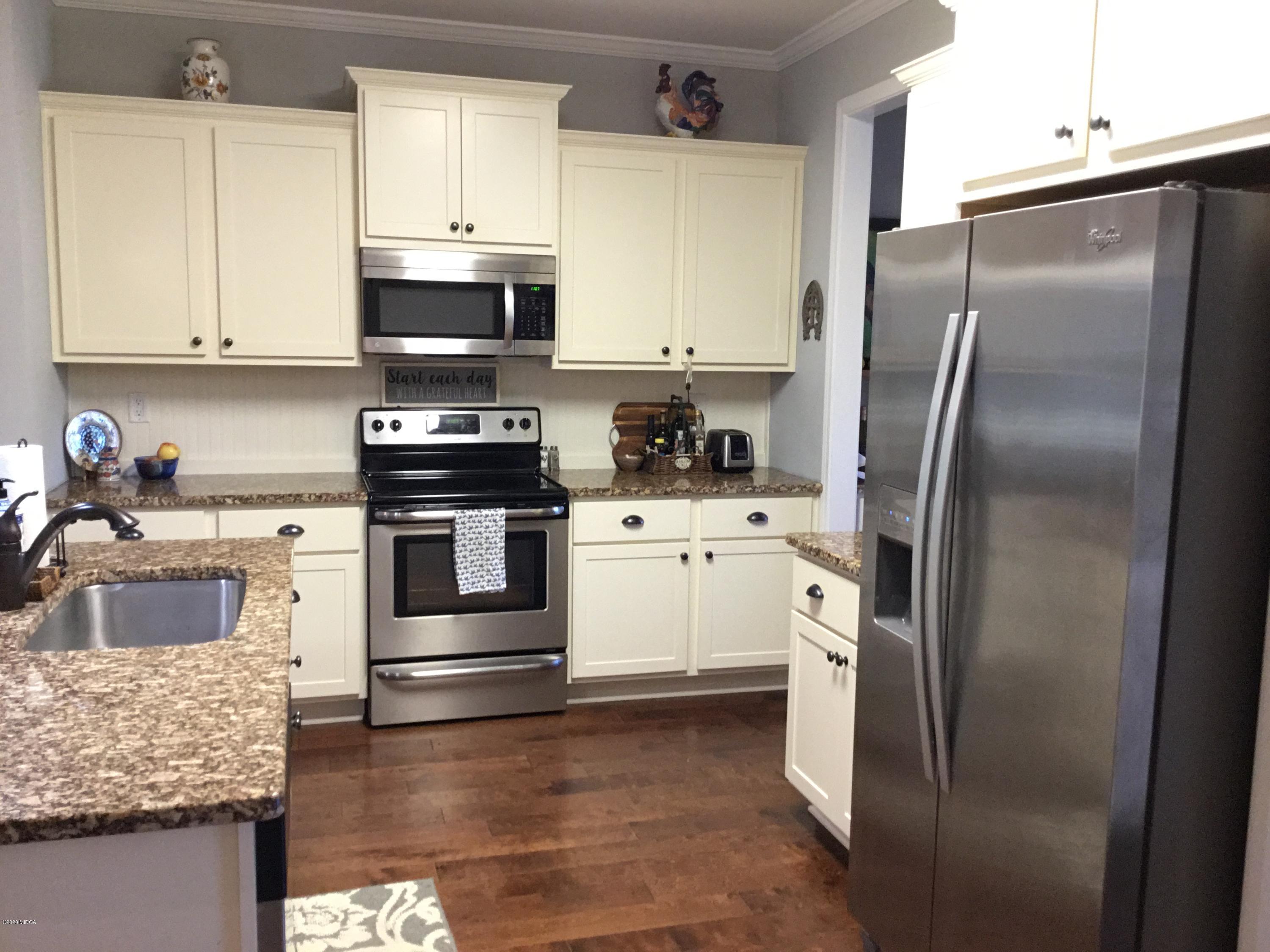324 Walnut Grove Road Gray, GA 31032 - Photo 10 of 37 a kitchen with stainless steel appliances granite countertop a refrigerator sink and stove