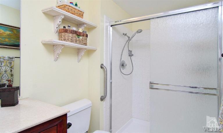 256 Kanan Road Oak Park, CA 91377 - Photo 16 of 26 a bathroom with a shower and a sink