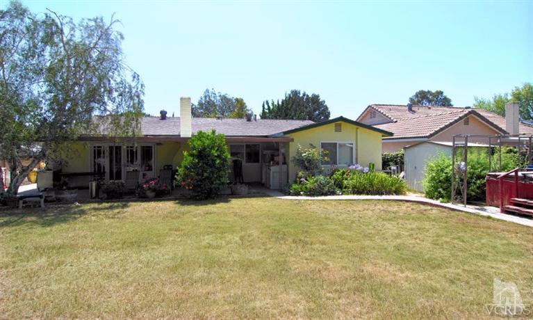 256 Kanan Road Oak Park, CA 91377 - Photo 24 of 26 a front view of a house with a garden