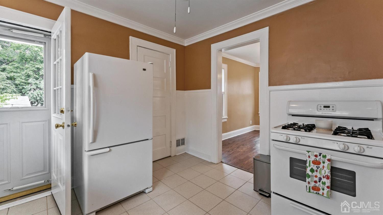 122 New Market Road Dunellen, NJ 08812 - Photo 11 of 28 a kitchen with a refrigerator and a stove