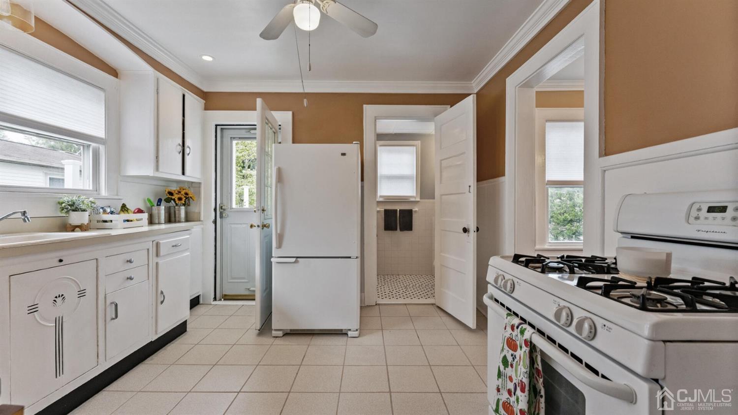 122 New Market Road Dunellen, NJ 08812 - Photo 12 of 28 a kitchen with appliances a sink and a stove
