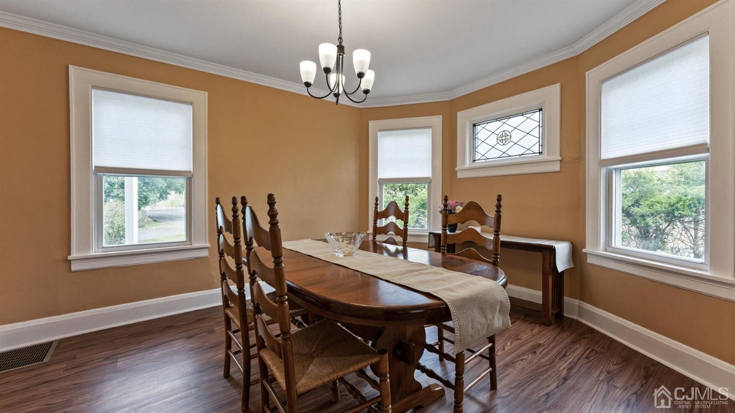 122 New Market Road Dunellen, NJ 08812 - Photo 13 of 28 a view of a dining room with furniture a chandelier and wooden floor