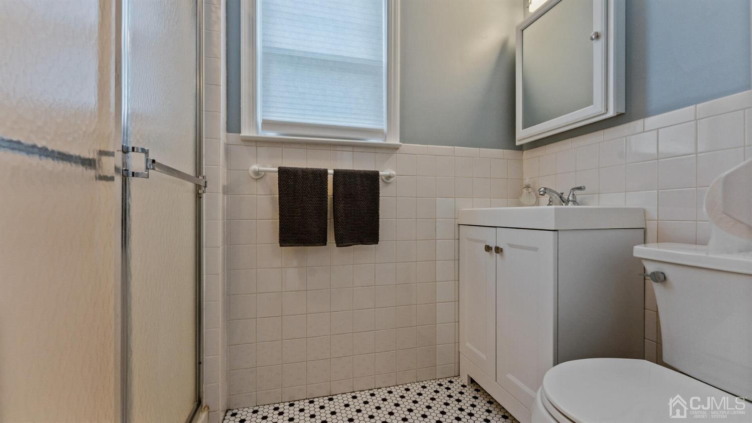 122 New Market Road Dunellen, NJ 08812 - Photo 15 of 28 a bathroom with a sink a toilet and shower