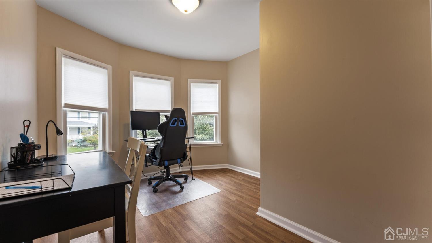 122 New Market Road Dunellen, NJ 08812 - Photo 19 of 28 a view of a workspace with furniture and a window
