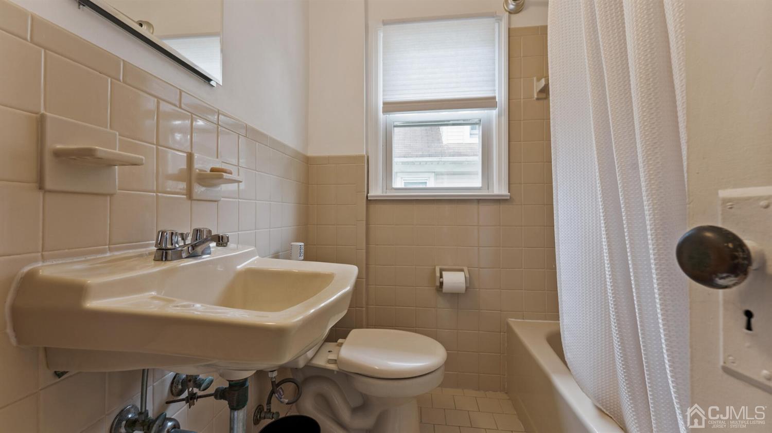 122 New Market Road Dunellen, NJ 08812 - Photo 20 of 28 a bathroom with a sink a toilet and a mirror