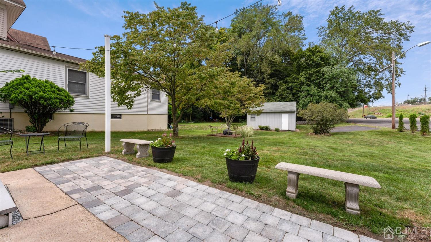 122 New Market Road Dunellen, NJ 08812 - Photo 23 of 28 a view of a chair and table in backyard of the house