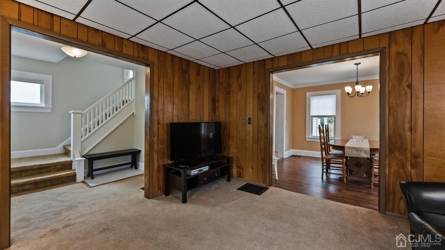 122 New Market Road Dunellen, NJ 08812 - Photo 7 of 28 a view of a livingroom with furniture and a flat screen tv