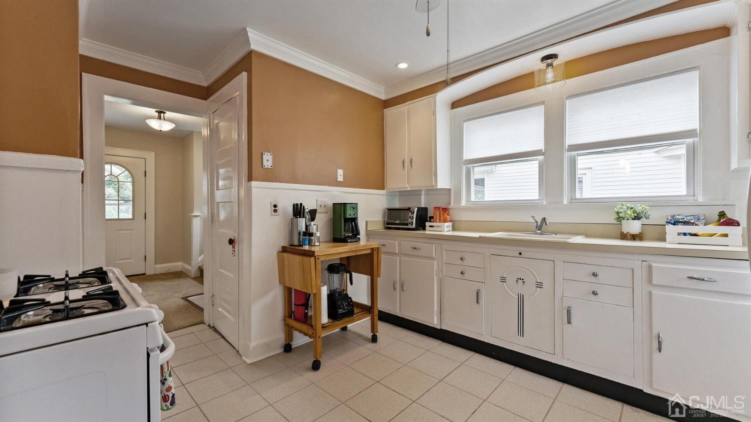122 New Market Road Dunellen, NJ 08812 - Photo 9 of 28 a kitchen that has a lot of cabinets in it and a window