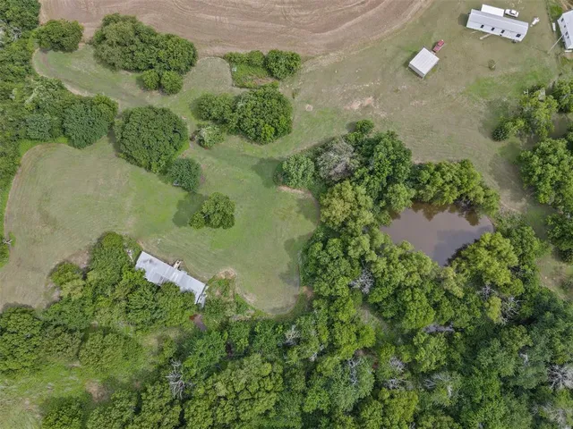 an aerial view of a house with a yard