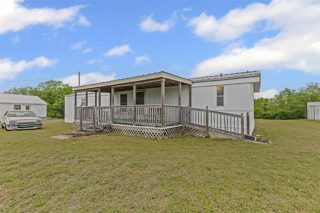 167 Hcr 4105 Covington, TX 76636 - Photo 8 of 32 View of front of home featuring a front lawn, a metal roof, and covered porch