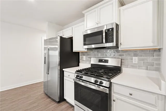 an empty room with a window and a ceiling fan