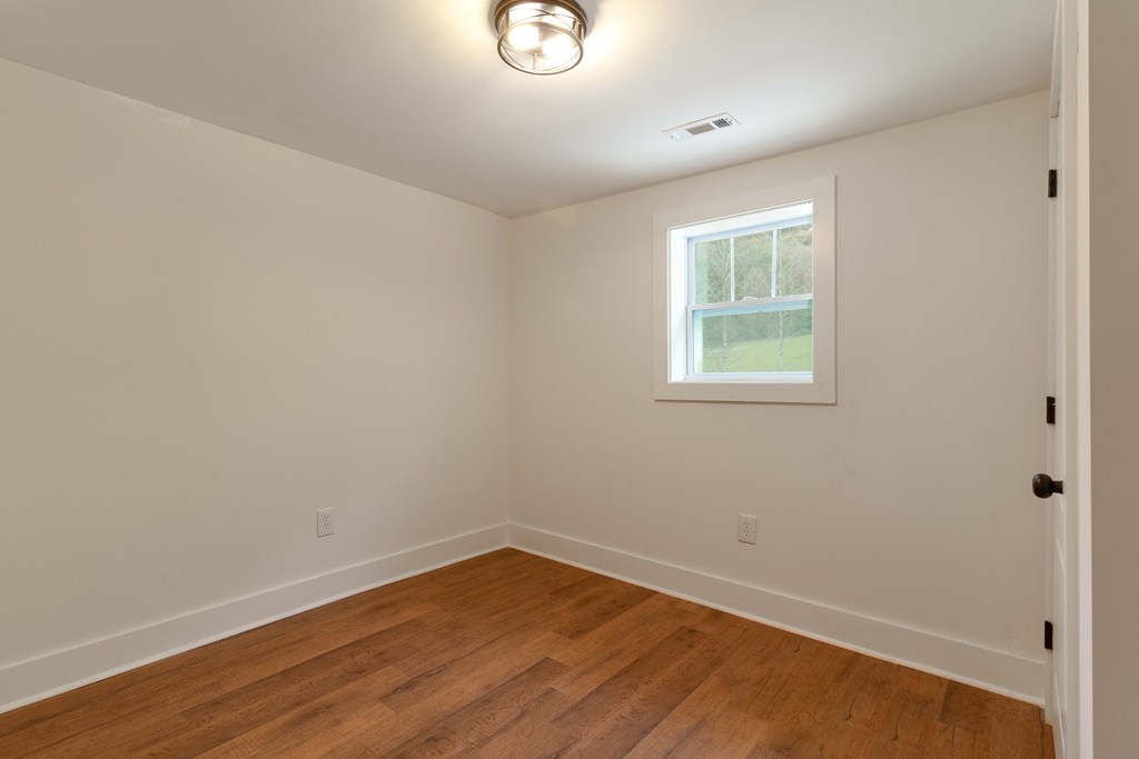 5107 Boiling Springs Road Murphy, NC 28906 - Photo 18 of 35 wooden floor in an empty room with a window