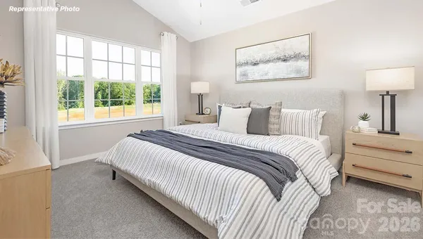 a bedroom with bed and a window