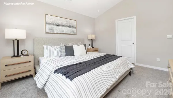 a bedroom with bed and a night stand