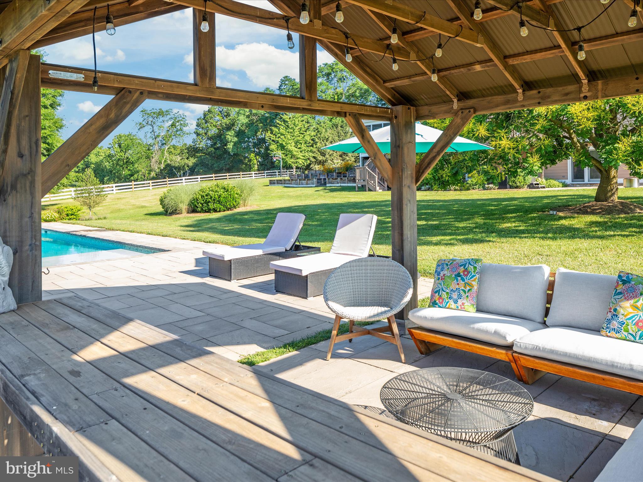 36823 Shoemaker School Road Purcellville, VA 20132 - Photo 5 of 59 a view of a patio with a table chairs and a backyard