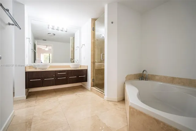 a bathroom with a granite countertop sink a toilet and shower