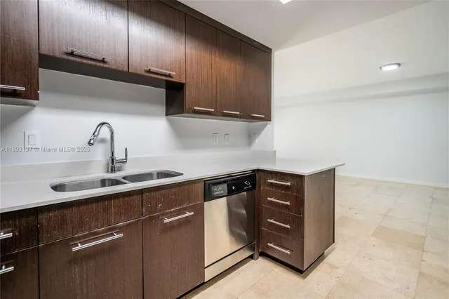 a kitchen with stainless steel appliances granite countertop a sink a stove and a refrigerator