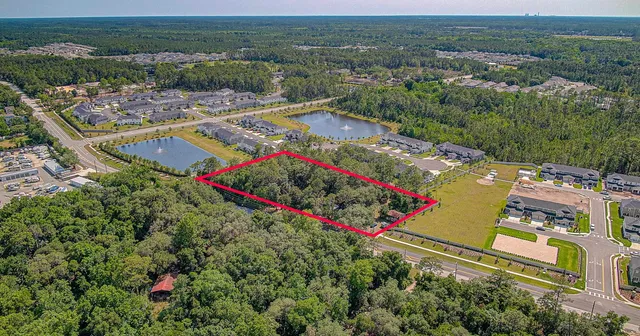 an aerial view of a houses with a swimming pool