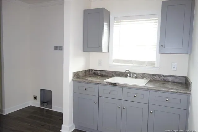 a bathroom with a granite countertop sink and a window