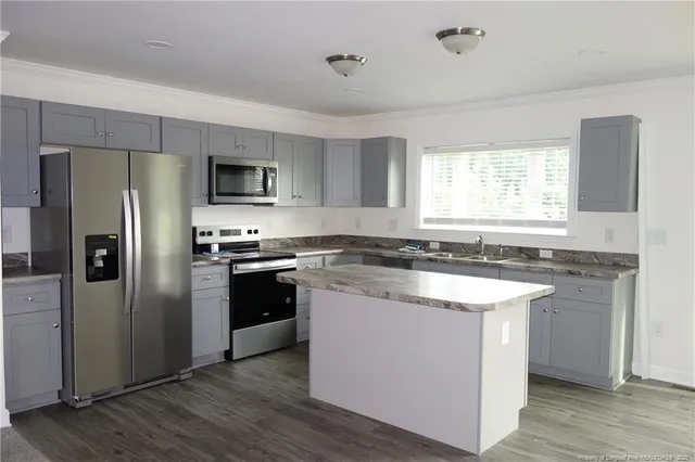 a kitchen with a refrigerator stove and sink