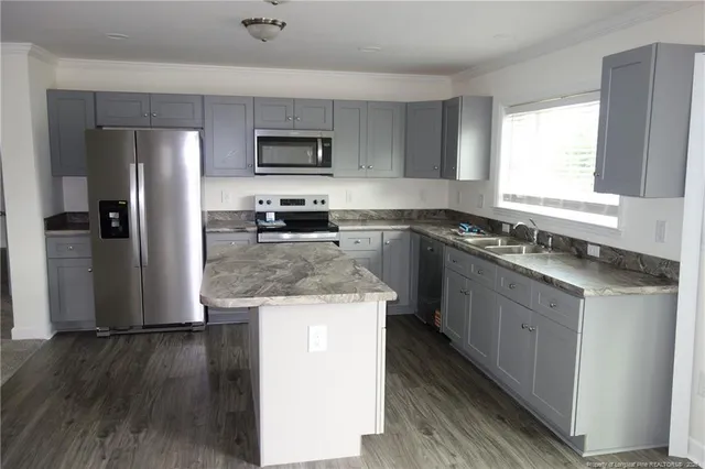 a kitchen with a sink stove and refrigerator