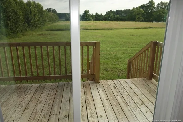 a view of a balcony with wooden floor and lake view