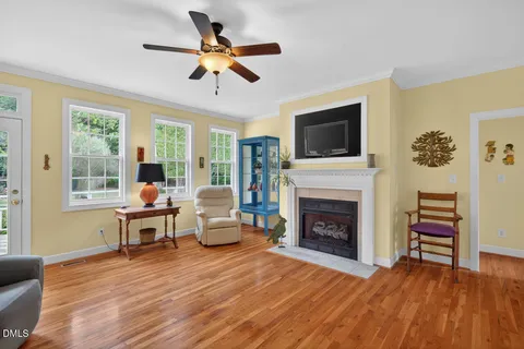 a view of a dining room with furniture a chandelier and wooden floor