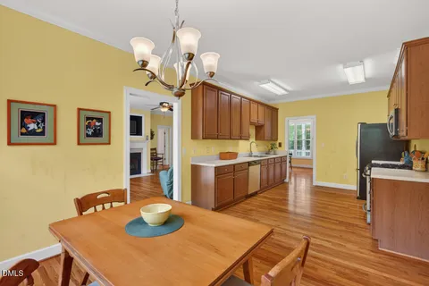 a large kitchen with stainless steel appliances granite countertop a stove a sink dishwasher and a refrigerator