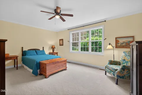 a bedroom with a bed and a ceiling fan
