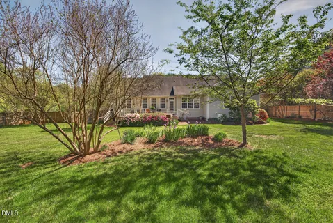 a front view of a house with a garden and yard