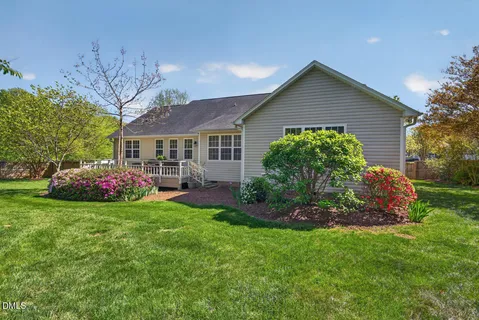 a view of a house with backyard and sitting area